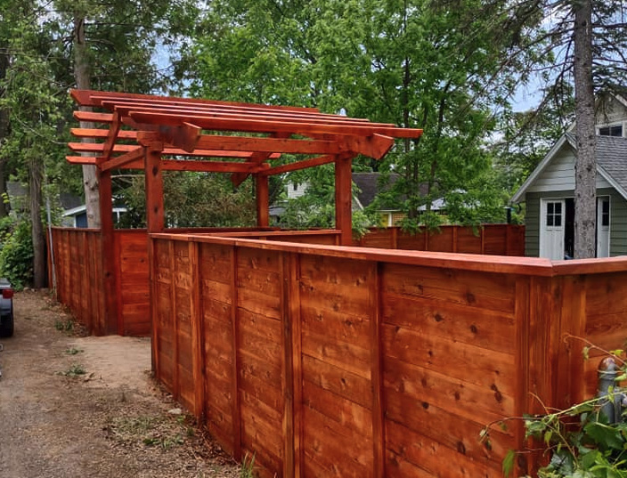 Photo of a stained wood pergola from a Grand Rapids MI fence company